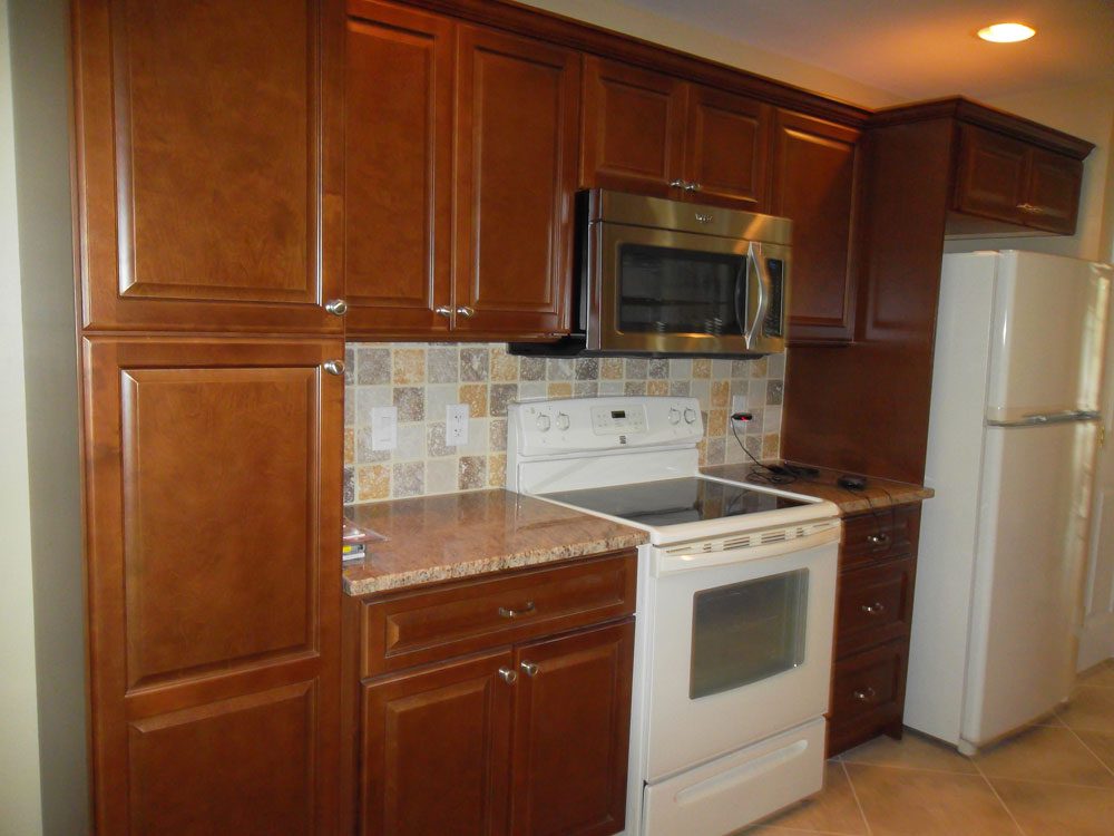 Kitchen remodel with updated wooden cabinets and modern tile backsplash | Sun Control Aluminum & Remodeling