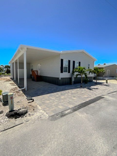 After image of newly installed aluminum carport and driveway pavers | Southwest Florida - Sun Control Aluminum & Remodeling